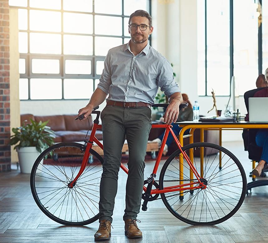 Man leaning on a desk with his bike