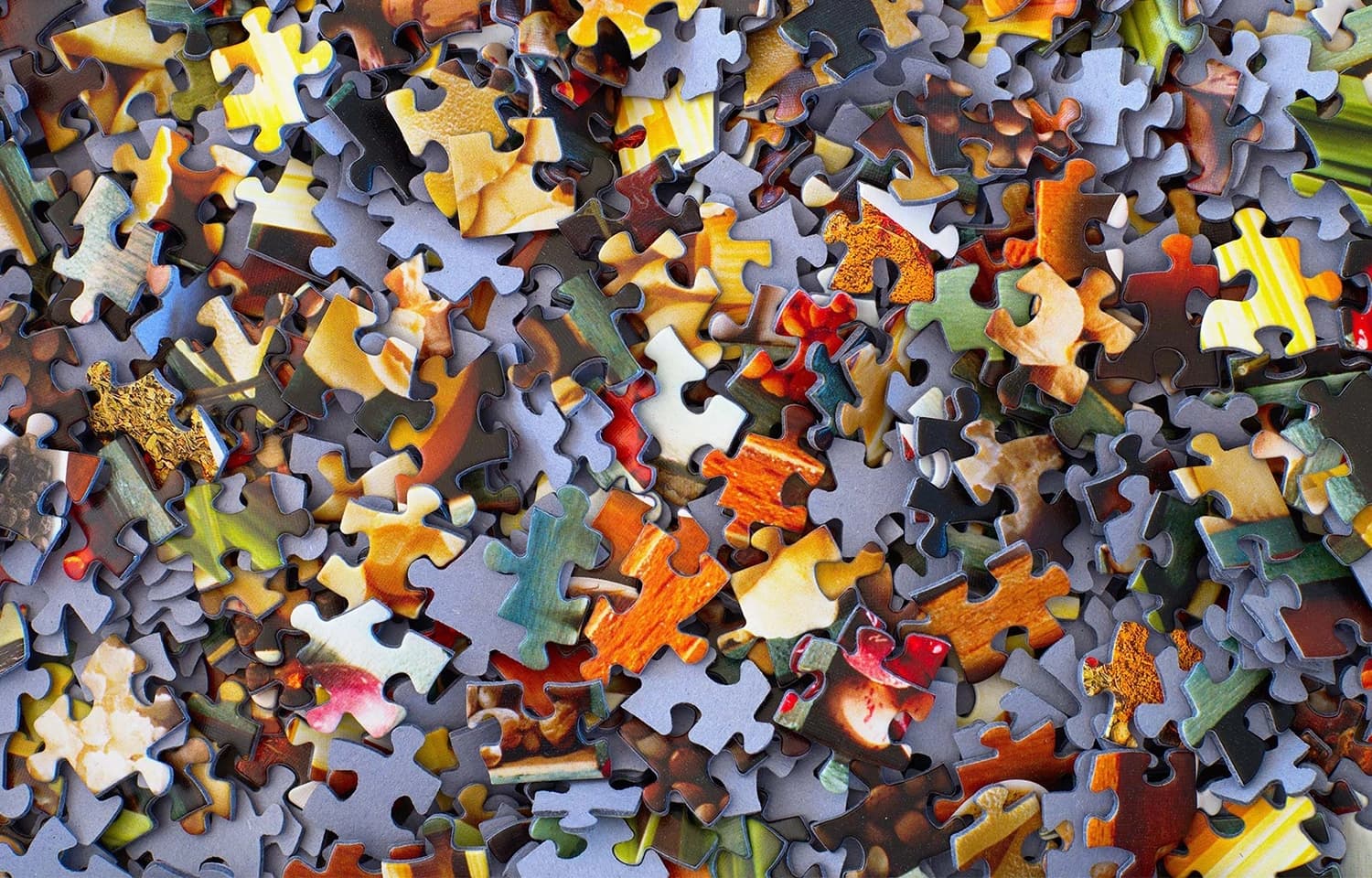 Ein chaotischer Puzzleteile-Haufen, der die Ausgangsposition von Chaos Engineering darstellt 